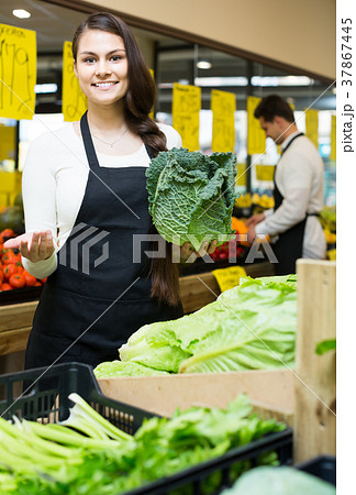 shop people standing near cabbage in grocery 37867445