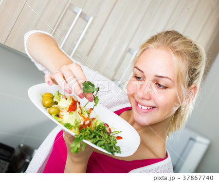girl preparing salad on kitchen girl preparing salad on kitchen 37867740