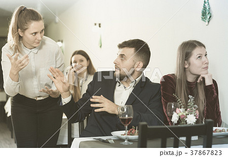 Man is talking with woman stranger in time dinner with girlfriend 37867823