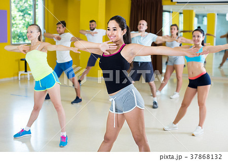 slim athletic women and men dancing strip plastic in class 37868132