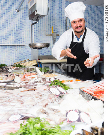 Man in cap showing fish 37868136