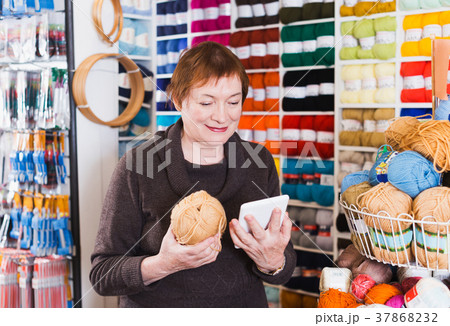 Woman with shopping bags using phone 37868232