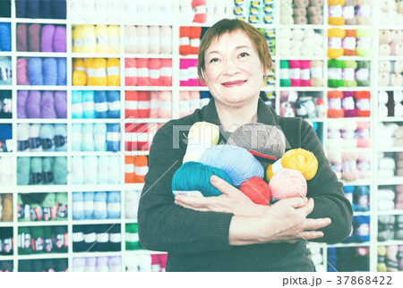 Mature female with colorful yarn for their hobby 37868422