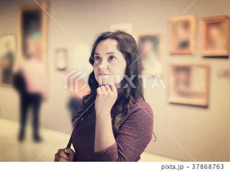 Adult girl watching at art collection exhibition Adult girl watching at art collection exhibition 37868763