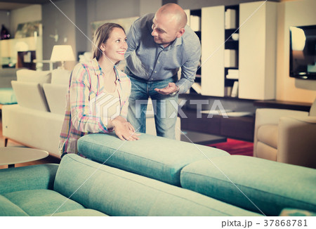 Cheerful female choosing new furniture in store Cheerful female choosing new furniture in store 37868781