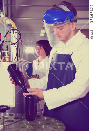 Male worker working with machine Male worker working with machine 37868829