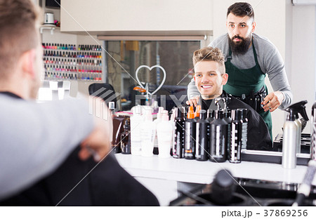 Hairdresser displaying result of work Hairdresser displaying result of work 37869256