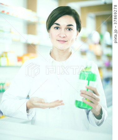 female pharmacist demonstrating assortment of pharmacy female pharmacist demonstrating assortment of pharmacy 37869278