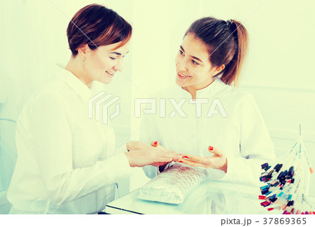 Woman doing manicure Woman doing manicure 37869365