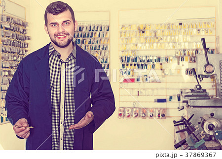 Positive man worker showing repaired key 37869367