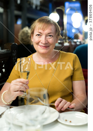 portrait of glad retiree woman sitting in cafe 37869406