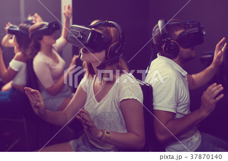 People wearing virtual reality goggles People wearing virtual reality goggles 37870140
