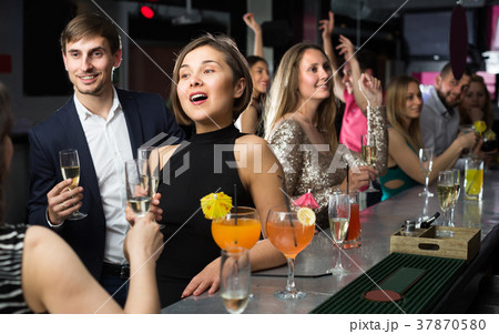 Young girl is drinking cocktails with colleague 37870580