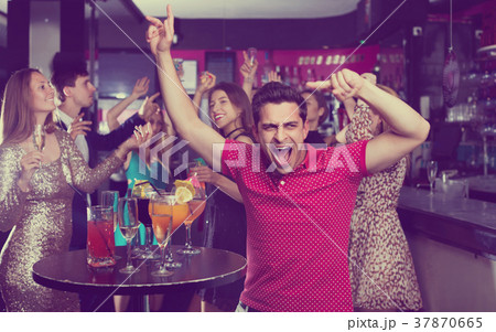 Portrait of smiling females and males having fun in the bar Portrait of smiling females and males having fun in the bar 37870665