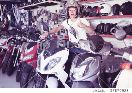 guy sitting on the motorbike with helmet guy sitting on the motorbike with helmet 37870923