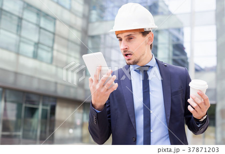 Portrait of man engineer working at touchpad 37871203