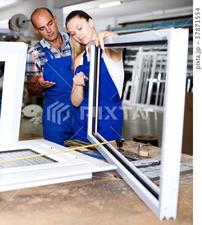 Female assembler of windows consulting with master Female assembler of windows consulting with master 37871554