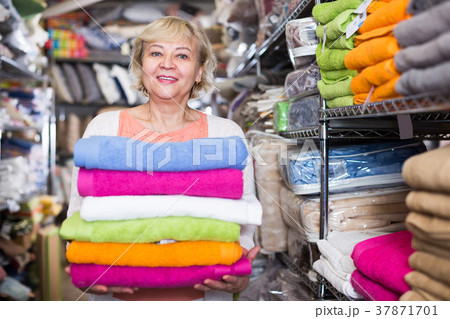 mature woman buying bath towels in the shop mature woman buying bath towels in the shop 37871701