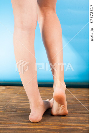 Close up a woman with itchy feet uses his big toe 37872817