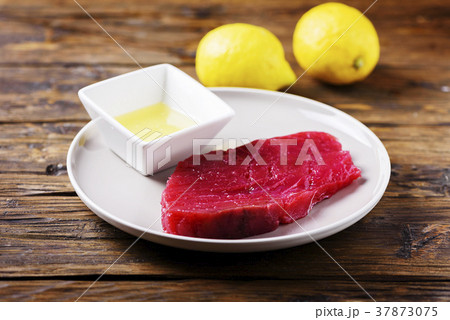 Raw fresh tuna fish on the wooden table 37873075