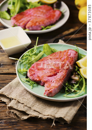 Cooked delicious tuna fish with green salad Cooked delicious tuna fish with green salad 37873085