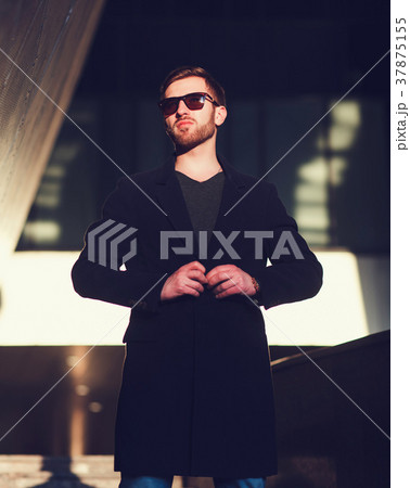Handsome young man in coat Handsome young man in coat 37875155