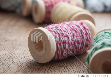 sewing thread spool bobbin on wooden table  37878963