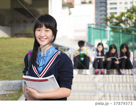 smiling girl Teenage Students standing  at campus 37879373