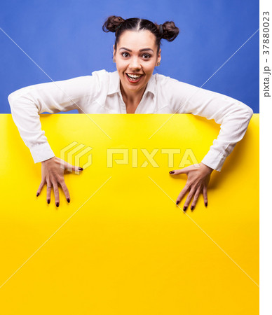 Woman next to a yellow board poster 37880023