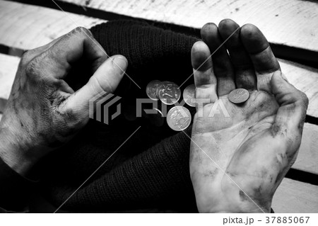 The beggar considers coins. Black and white 37885067