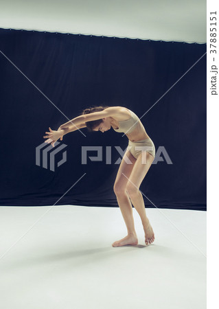 Young teen dancer ion white floor background. 37885151