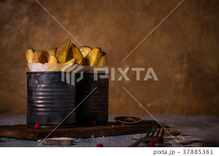 Two worn cans with fried potato stripes Two worn cans with fried potato stripes 37885361