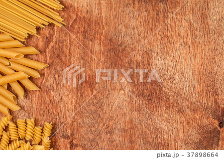 Assortment of different shape pastas on wooden 37898664