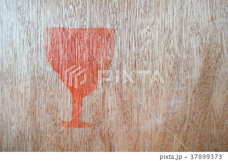 Close up of fragile symbol on wood board. 37899373