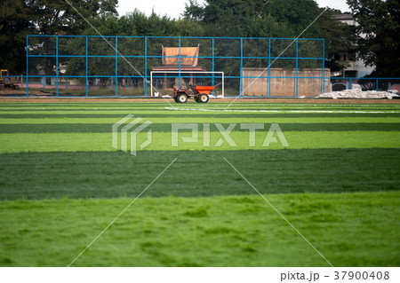 Orange truck with Artificial green grass 37900408
