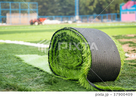 Roll of artificial grass on new soccer field 37900409
