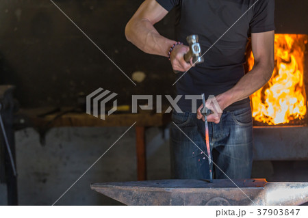 farrier making a traditional horseshoe on a forge farrier making a traditional horseshoe on a forge 37903847