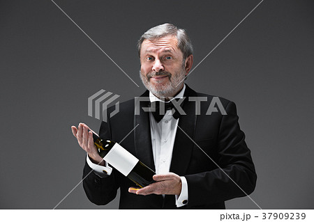professional waiter in uniform is serving wine 37909239