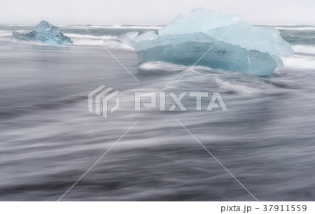 Melting ice floating in Jokulsarlon beach, Iceland Melting ice floating in Jokulsarlon beach, Iceland 37911559