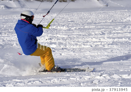 A male athlete engaged in snow kiting A male athlete engaged in snow kiting 37913945