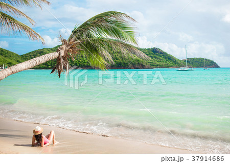 Young slim woman in bikini and straw hat lying on Young slim woman in bikini and straw hat lying on 37914686