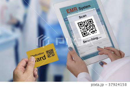 Doctor using tablet computer to scan QR code. 37924158