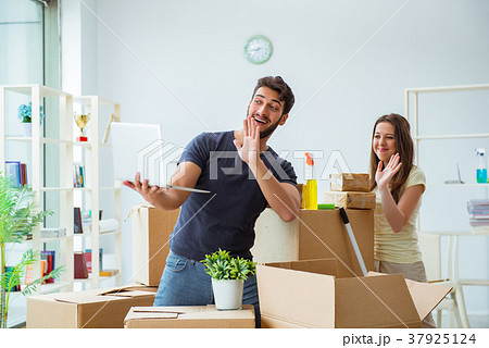 Young family unpacking at new house with boxes 37925124