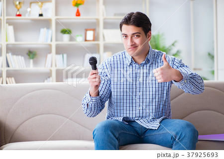 Funny man singing songs in karaoke at home Funny man singing songs in karaoke at home 37925693