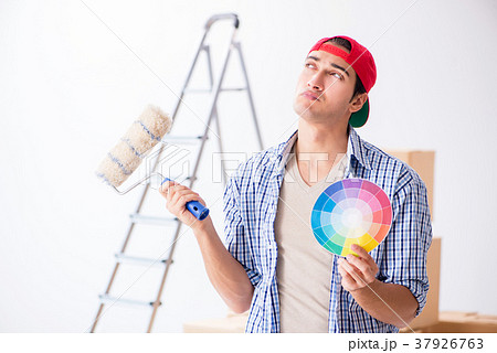 Young painter contractor choosing colors for home Young painter contractor choosing colors for home 37926763