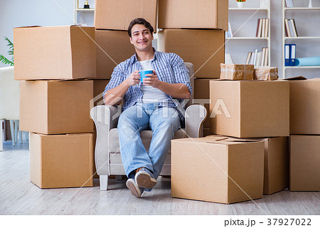 Young man moving in to new house with boxes Young man moving in to new house with boxes 37927022