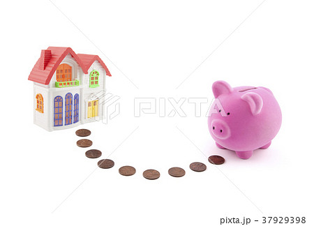 Piggy bank with coins and house miniature. 37929398