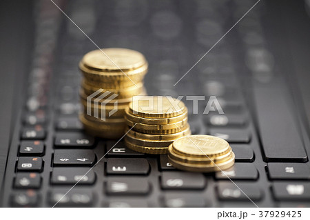Rising coins on keyboard  37929425