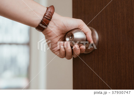 Male hand open door knob or opening the door 37930747
