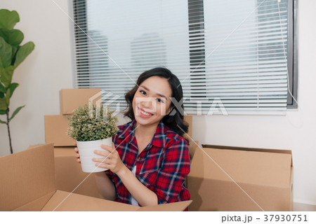 Portrait of happy woman during moving home  37930751